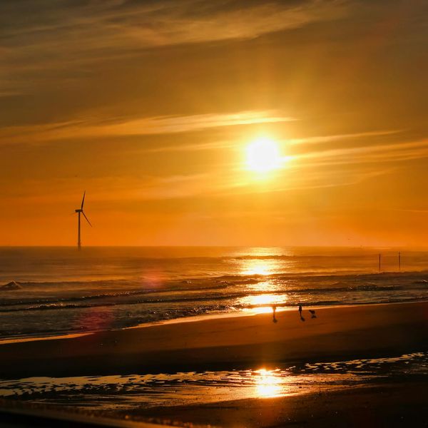 Silhouette of a person stretching during sunrise, symbolizing renewed energy.